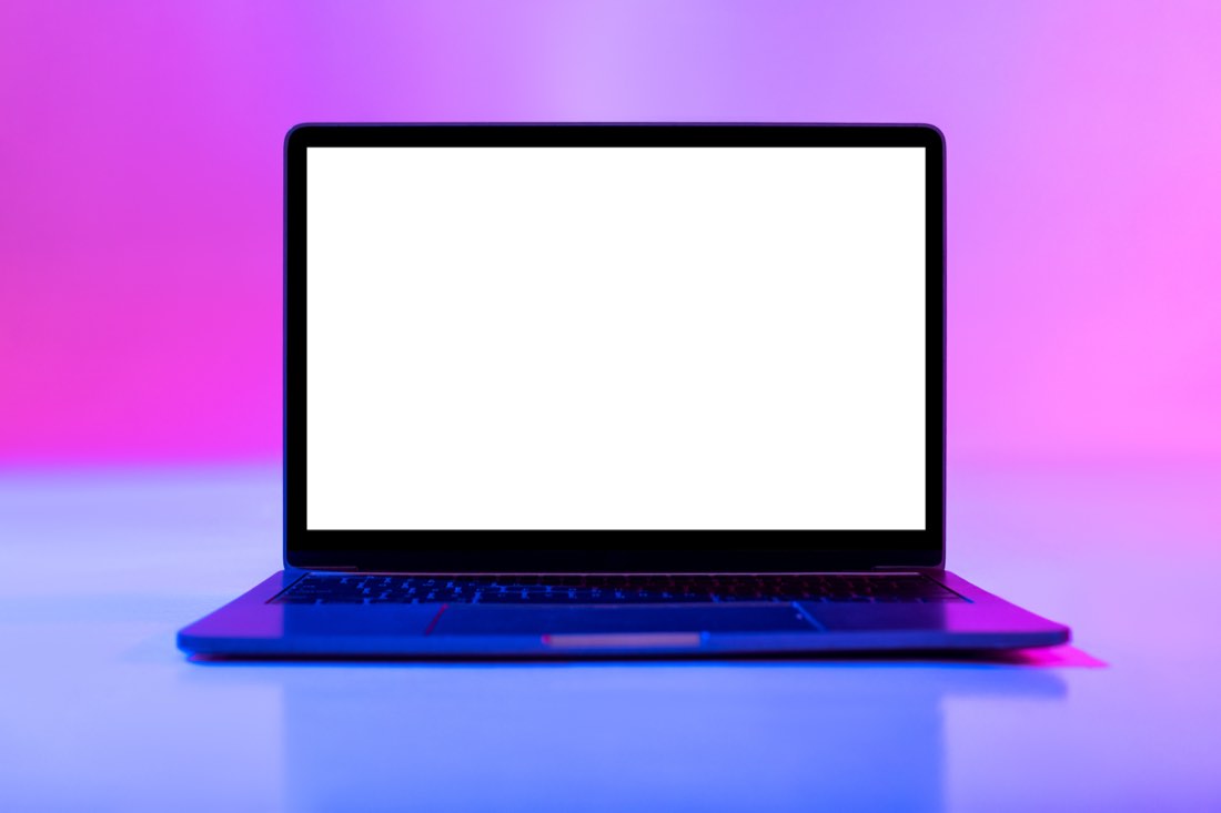 Laptop showing a website design in neon light